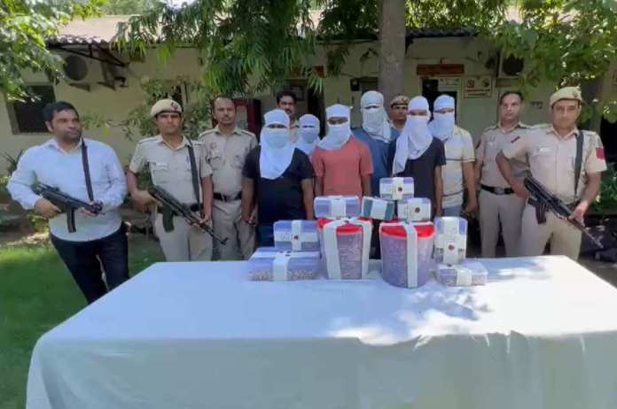 Delhi Police with the accused and cartridges